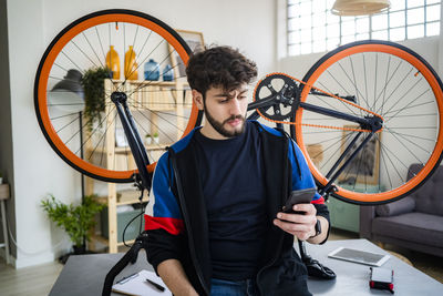 Man standing by bicycle