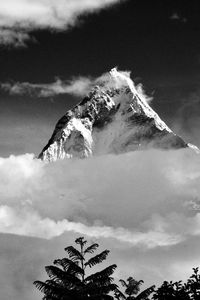 Scenic view of mountains against cloudy sky