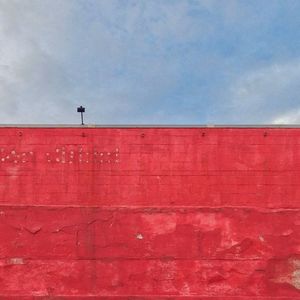 Low angle view of built structure against cloudy sky