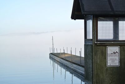 Built structure by lake against sky