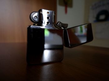Close-up of cigarette lighter on table