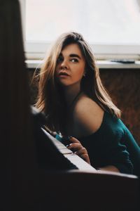 Portrait of a young woman sitting outdoors