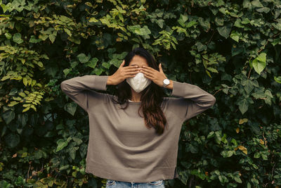 Woman standing by plants