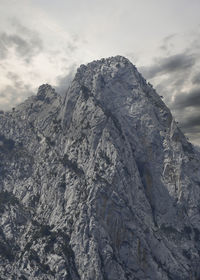 Low angle view of rocky mountain against sky