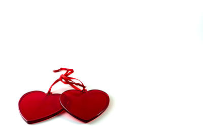Close-up of red heart shape over white background