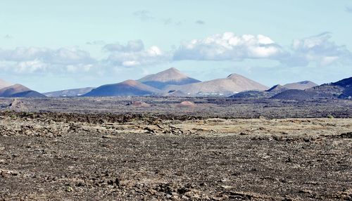 Scenic view of arid landscape against sky