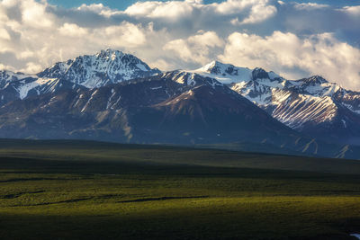 Scenic view of snowcapped mountains against sky