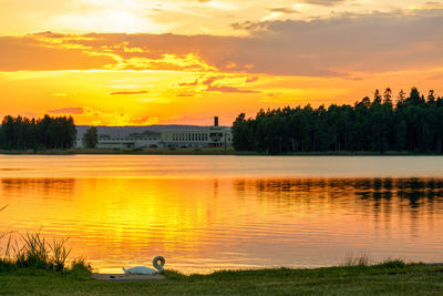 Scenic view of lake against orange sky