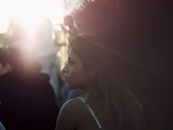 Rear view of woman looking away while standing outdoors