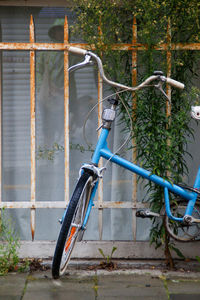 Vintage and old blue rusty bicycle abandoned in the city