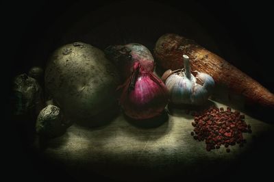 Close-up of fruits on table against black background