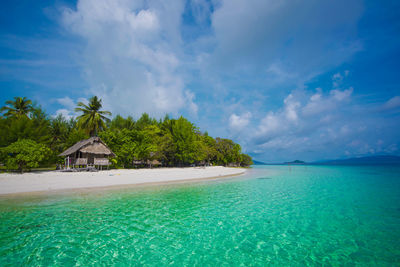 Scenic view of swimming pool by sea against sky