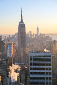 Cityscape against clear sky during sunset