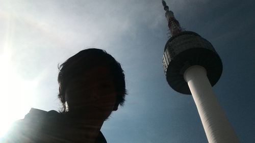 Low angle view of communications tower against sky