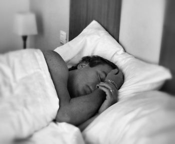 Close-up of baby sleeping on bed