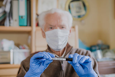 Portrait of doctor holding test tube with text