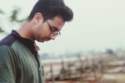 Side view of thoughtful young man looking away