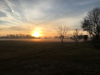 Scenic view of field against sky during sunset