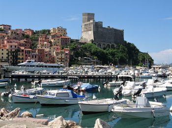 Boats moored at harbor in lerici, italy 