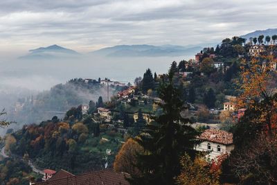 Panoramic view of houses and mountains against sky