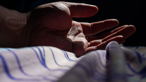 Close-up of baby lying on bed