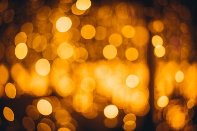 Defocused image of illuminated christmas lights at night