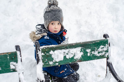 Boy with sled on snow