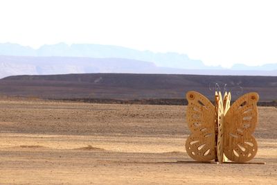 High angle view of shoes on desert against sky