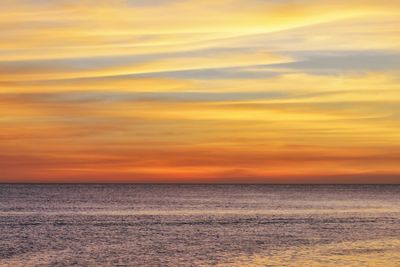 Scenic view of sea against sky at sunset