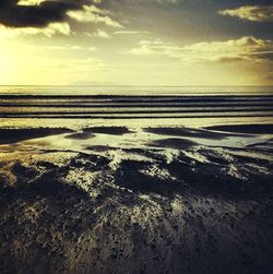 Scenic view of sea against cloudy sky