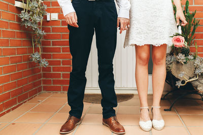 Low section of friends standing on floor