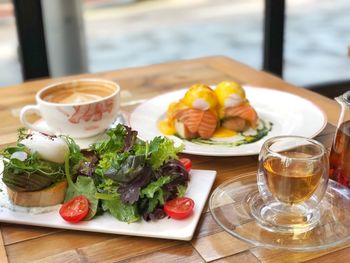 High angle view of breakfast served on wooden table