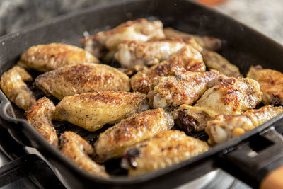 Close up of grill with chicken wings.