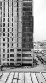 View of construction site by building in city against sky