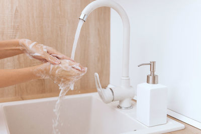 Washing hands in sink