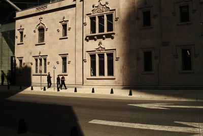 Shadow of woman walking on road