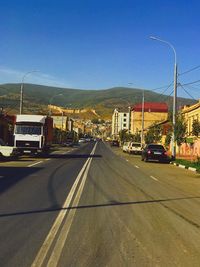 Cars on road against clear sky