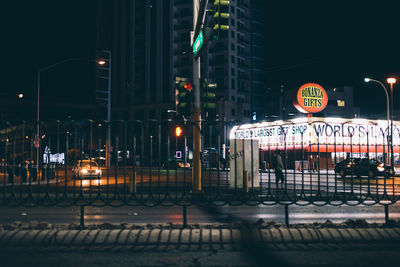 Illuminated city street at night