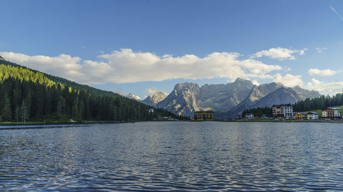 Scenic view of river and mountains against sky