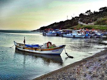 Boats moored on sea against sky