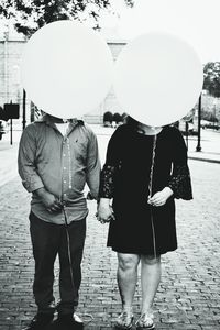 Rear view of woman holding umbrella