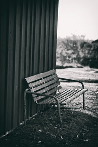 Close-up of empty bench in field