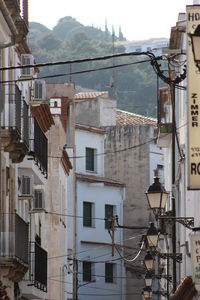 Residential buildings in city against sky