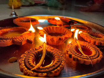 High angle view of lit candles on table