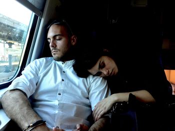 Couple sleeping in train