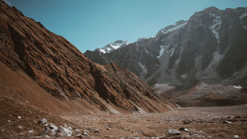 Scenic view of mountains and valley against clear sky