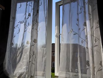 Low angle view of building seen through window