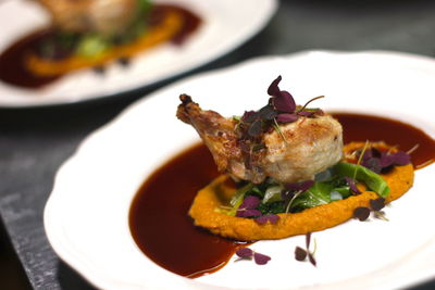 Close-up of chicken in plate on table