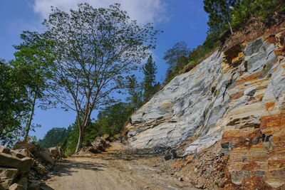 Low angle view of rocks on mountain against sky