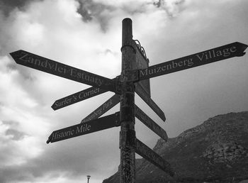 Low angle view of sign board against sky